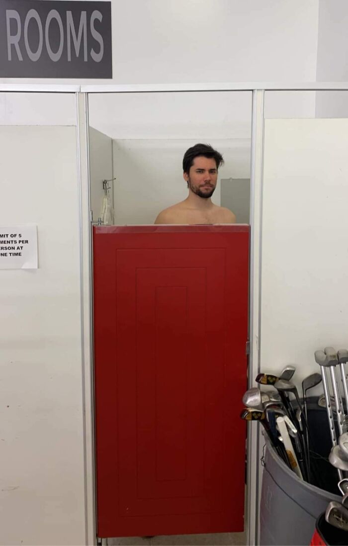 Man struggling with low shower door height, illustrating common tall people struggles shared online.