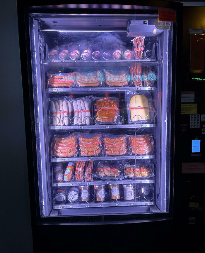 Vending machine filled with various packaged sausages and deli meats, showcasing impressive country implementations