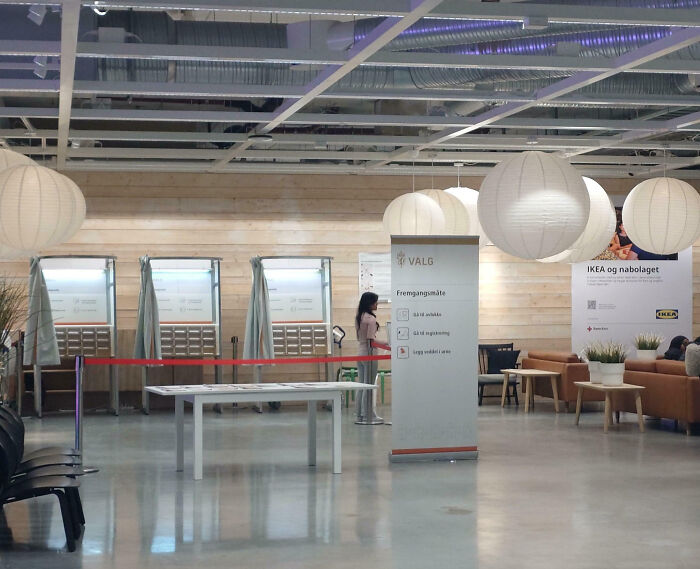 Modern voting booths in a well-lit public space showcasing impressive things countries implemented for efficient voting.