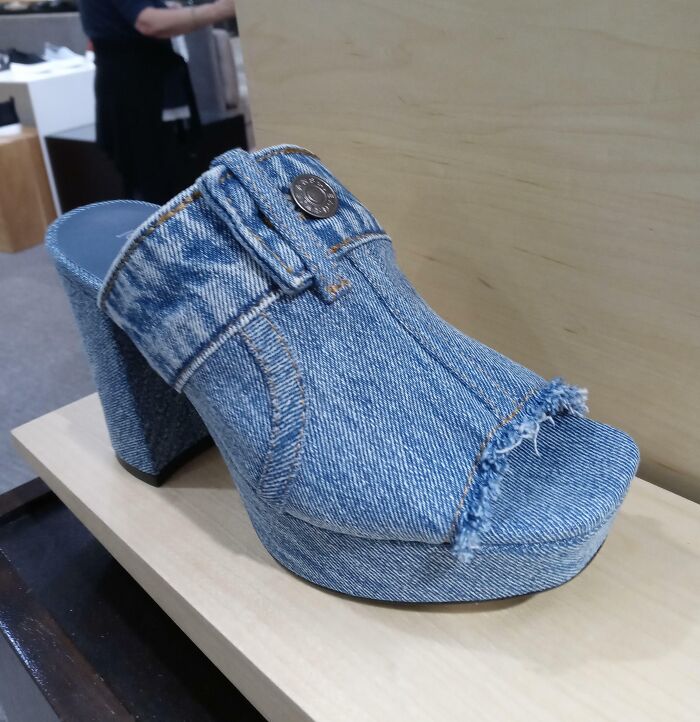 Denim platform high heel shoe with frayed edges and button detail, showcasing a hilarious fashion fail design.