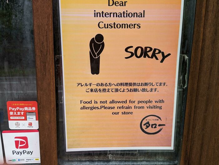 Sign showing a humorous English translation error in Japan warning customers with allergies not to bring food.