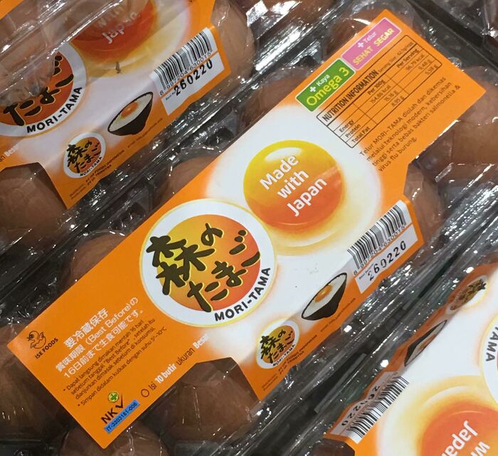 Egg carton packaging from Japan with humorous English translation errors and nutritional information labels.