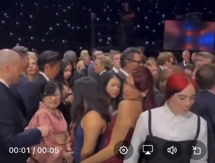 A crowded event scene with people posing awkwardly, capturing pop culture moments that made people cringe hard.