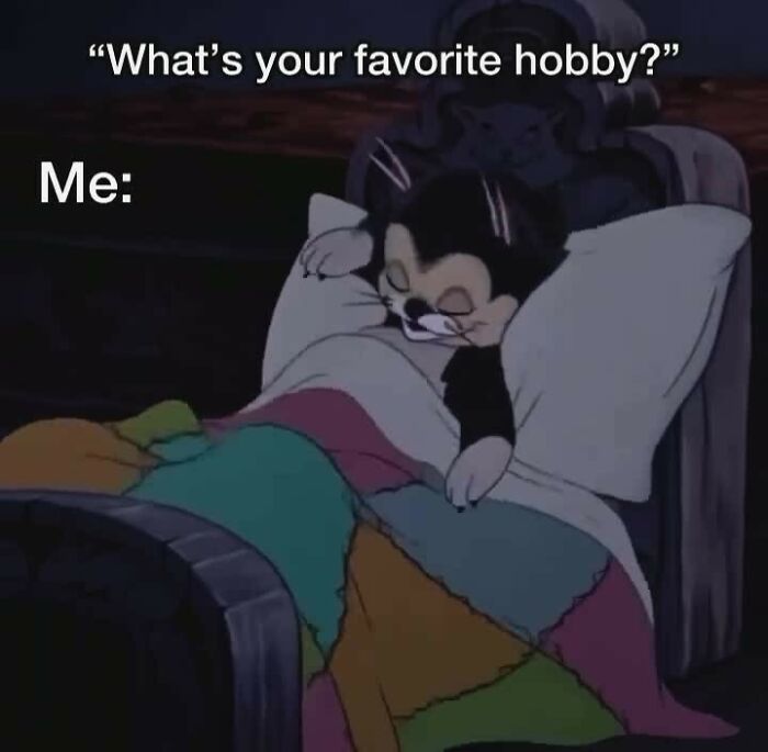 Animated cat sleeping in bed under a colorful quilt, illustrating humor as a coping mechanism meme.