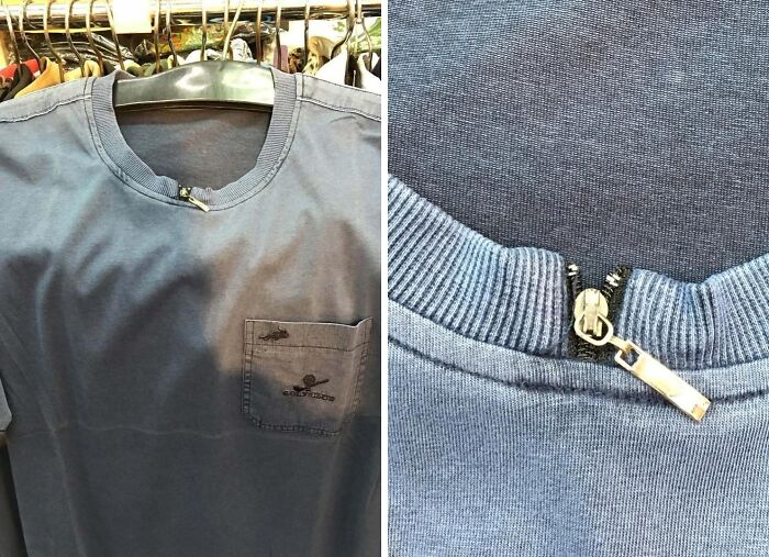 Blue shirt with a zipper closing the collar incorrectly causing a hilarious fashion fail in clothing design.