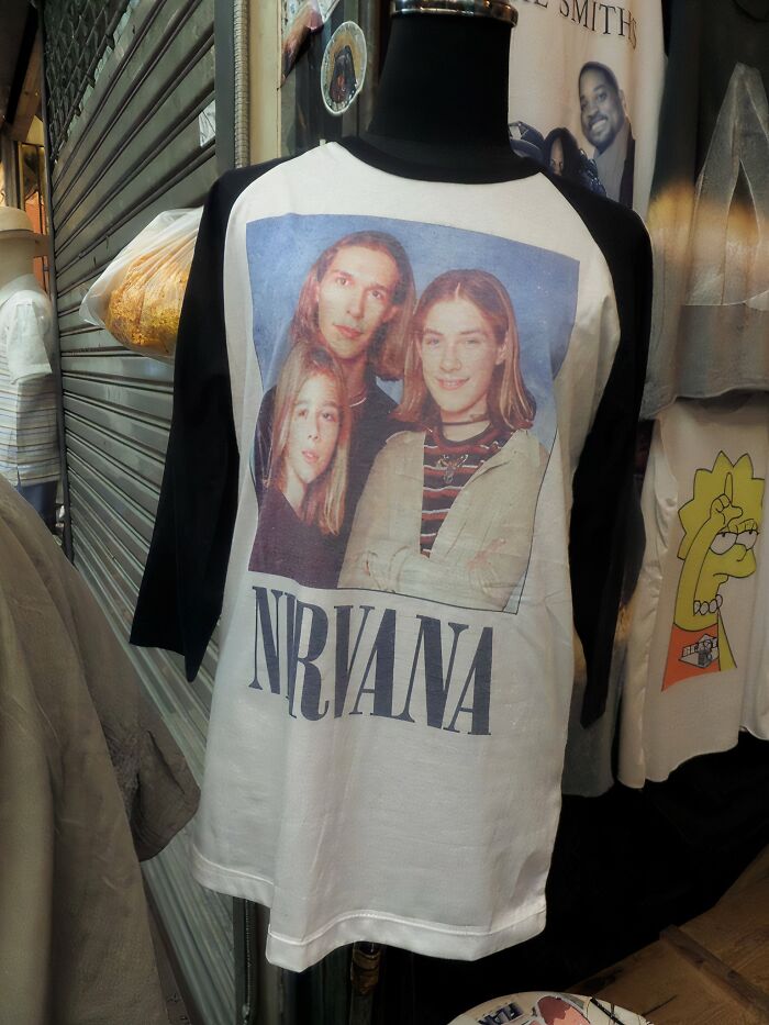 Mannequin wearing a black and white long sleeve shirt featuring a misprinted Nirvana band photo, showcasing hilarious fashion fails.