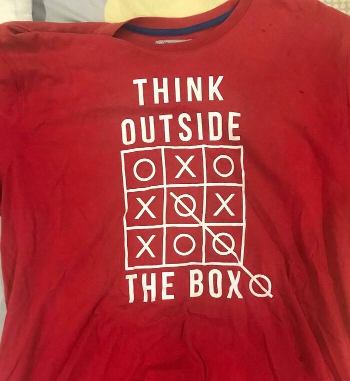 Red t-shirt with a tic-tac-toe design and the phrase think outside the box featuring a humorous fashion fail.