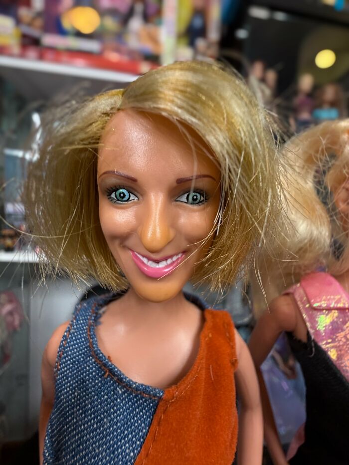 Offensively ugly celebrity doll with messy blonde hair and exaggerated facial features in a colorful outfit.
