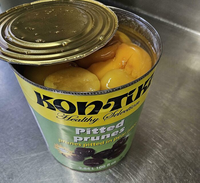 Open can of pitted prunes showing unusually large yellow fruit inside, an unhinged image that caught people off-guard