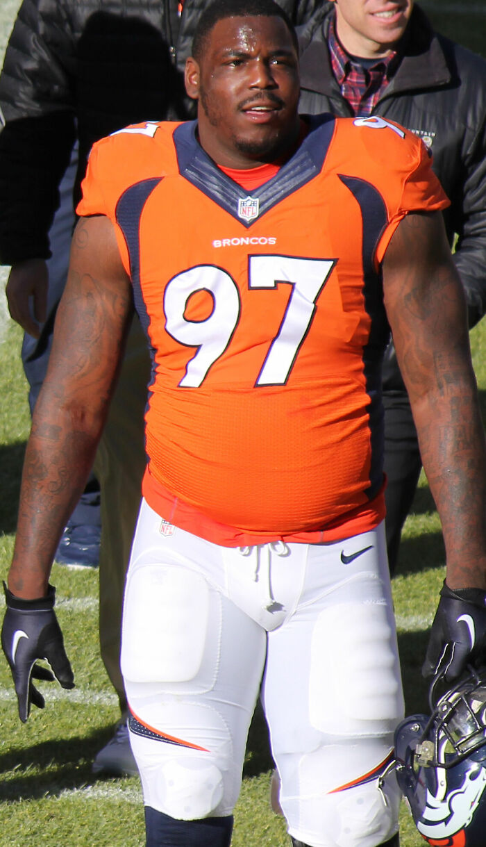 Malik Jackson in Denver Broncos uniform number 97 on the field during an NFL game, showing a focused expression.
