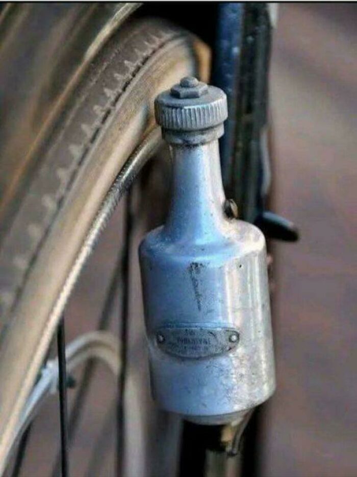 Vintage bicycle accessory mounted near the tire, a nostalgic item to make you feel old as heck.