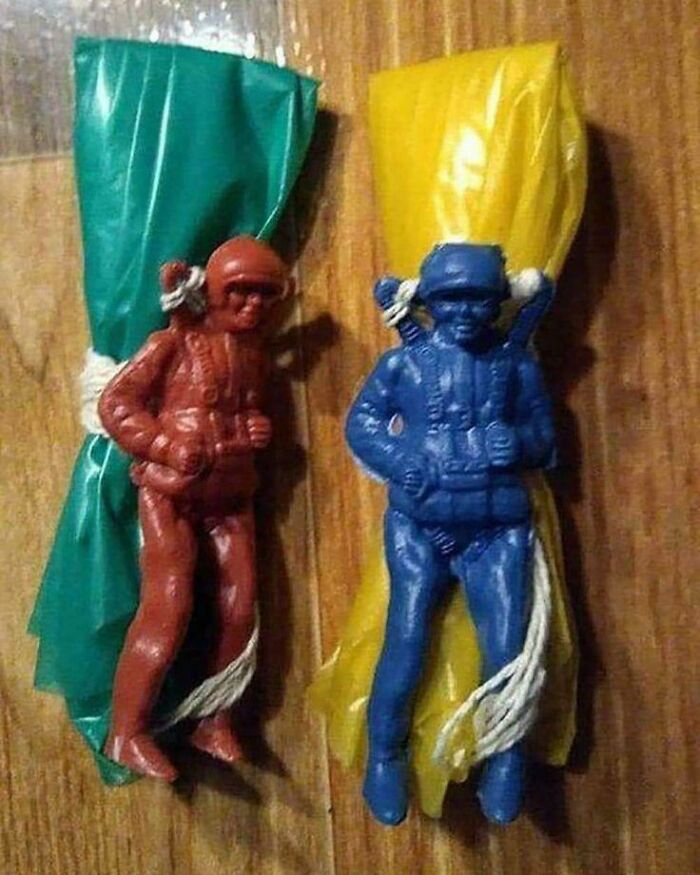 Plastic toy parachute men with green and yellow parachutes, nostalgic childhood items to make you feel old.