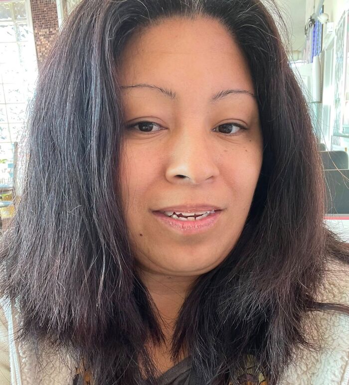 Woman with messy, uneven hair showcasing one of the disastrous hairstyles that may raise questions about life decisions.