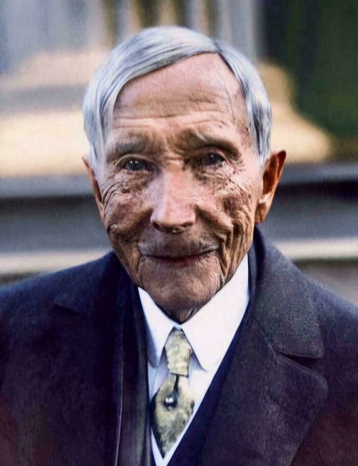 Eerie old-school photo of an elderly man with deep wrinkles and a faint smile, evoking a slightly cursed feeling.