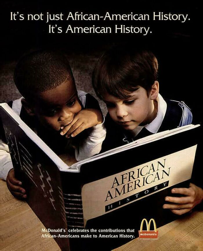 Two children reading a vintage advertisement book on African American history highlighting American history contributions.
