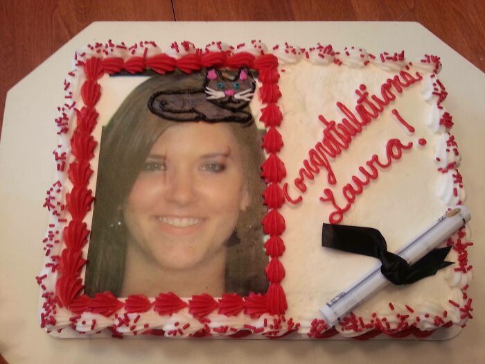 Photo cake with a smiling woman's face, red icing border, and congratulatory message, showcasing funny cake design emotions.
