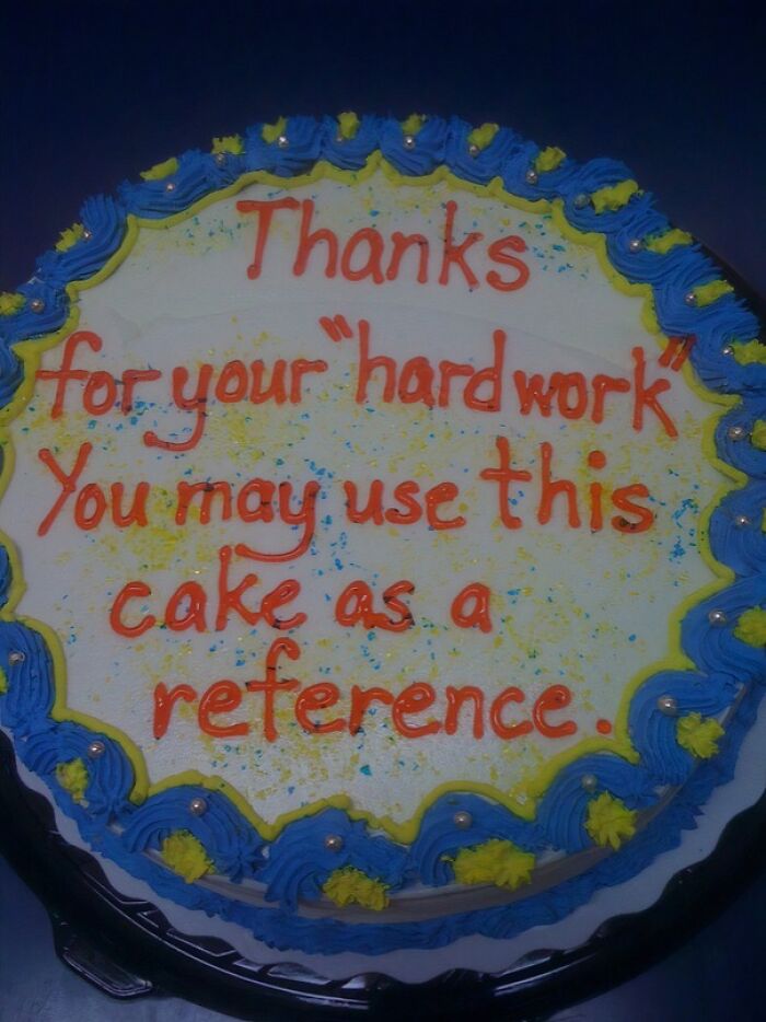 Funny cake with sarcastic message thanking hard work, decorated with blue and yellow icing and colorful sprinkles.