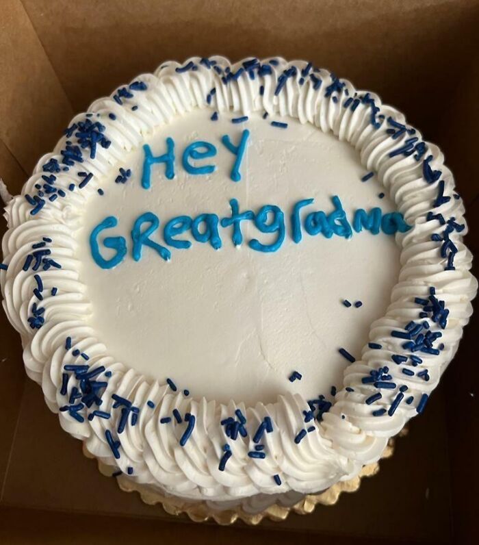 Round white frosted cake with blue sprinkles and misspelled message reflecting funny emotions on cake designs.