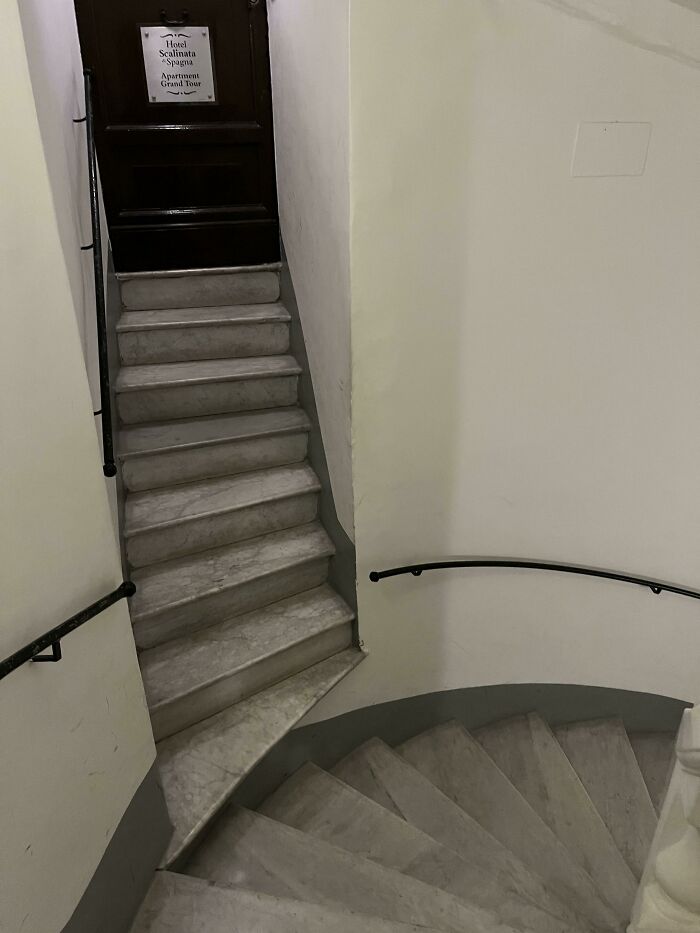 Narrow staircase with awkward turn and uneven steps showcasing terrible product design and poor usability.