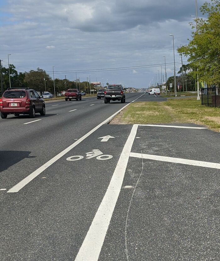 Bike lane design flaw ending abruptly into a parking area, illustrating terrible product designs that make no sense.