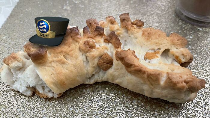 Burnt and misshapen dessert with an added captain’s hat, illustrating a failed attempt to ruin dessert creatively.