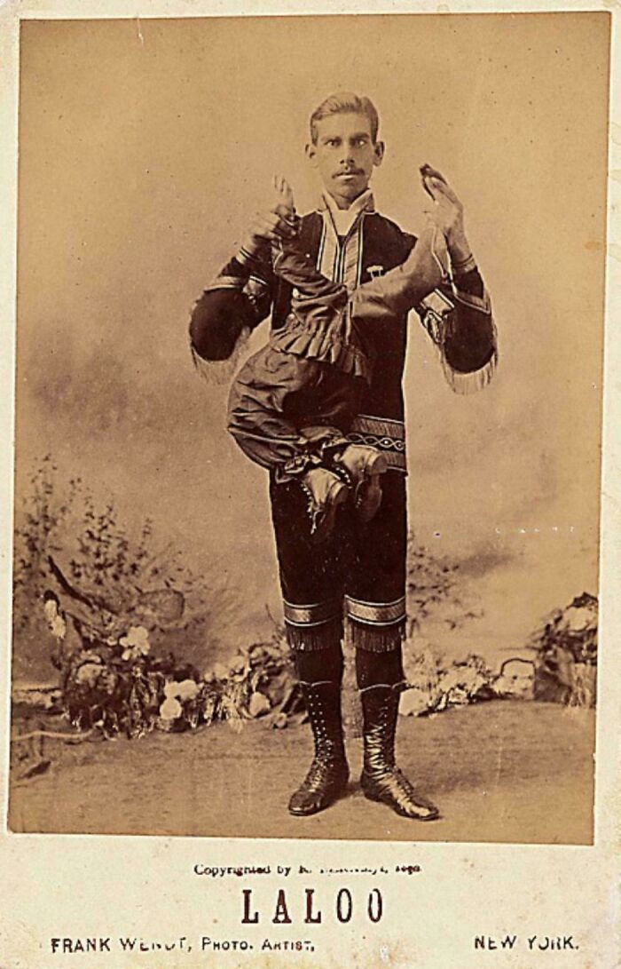 Victorian era performer holding a contorted figure in vintage costume, showcasing unique entertainment styles of the time.