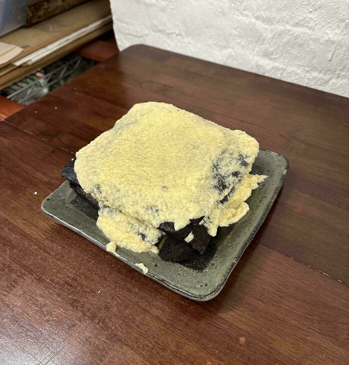 Burnt dessert covered in an uneven layer of crumbly frosting, showcasing another way people managed to ruin dessert.