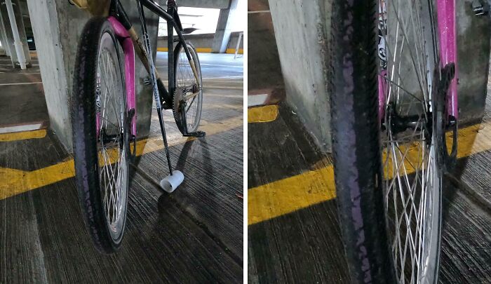 Worn down bicycle tire and frame in a parking garage showing everyday objects worn down in unexpected ways.