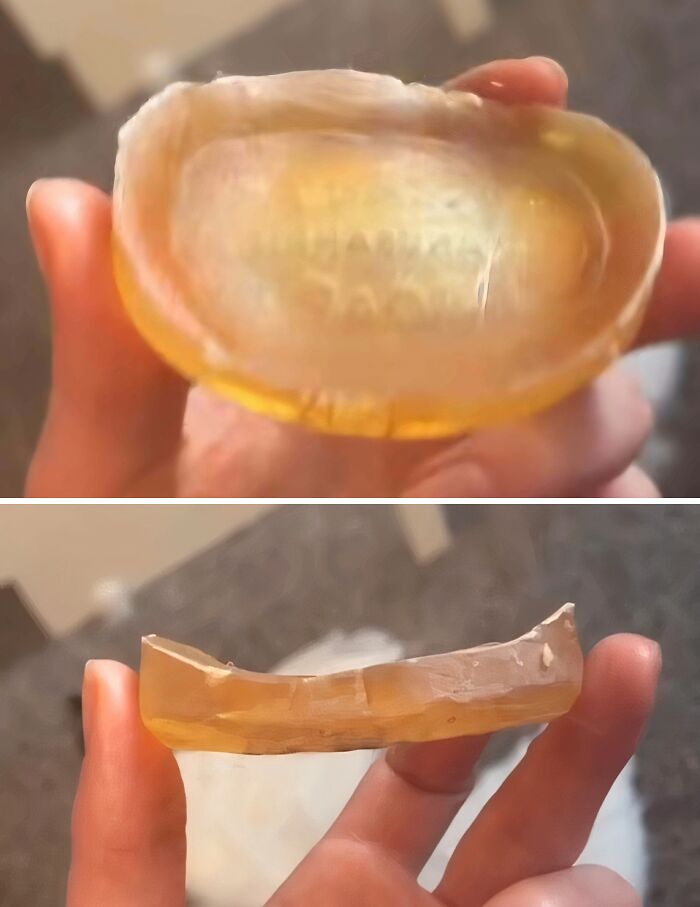 Worn down translucent soap bar held in hand showing unexpected wear and smooth edges on everyday object.