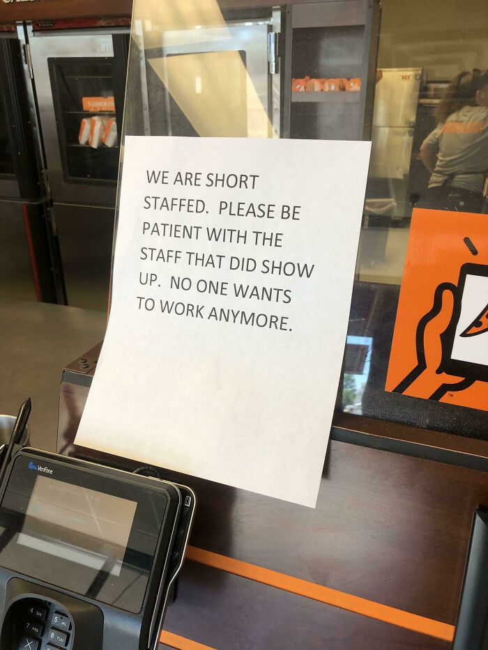 Sign at counter reads short staffed asking for patience with remaining staff, illustrating relatable recruitment nightmares.