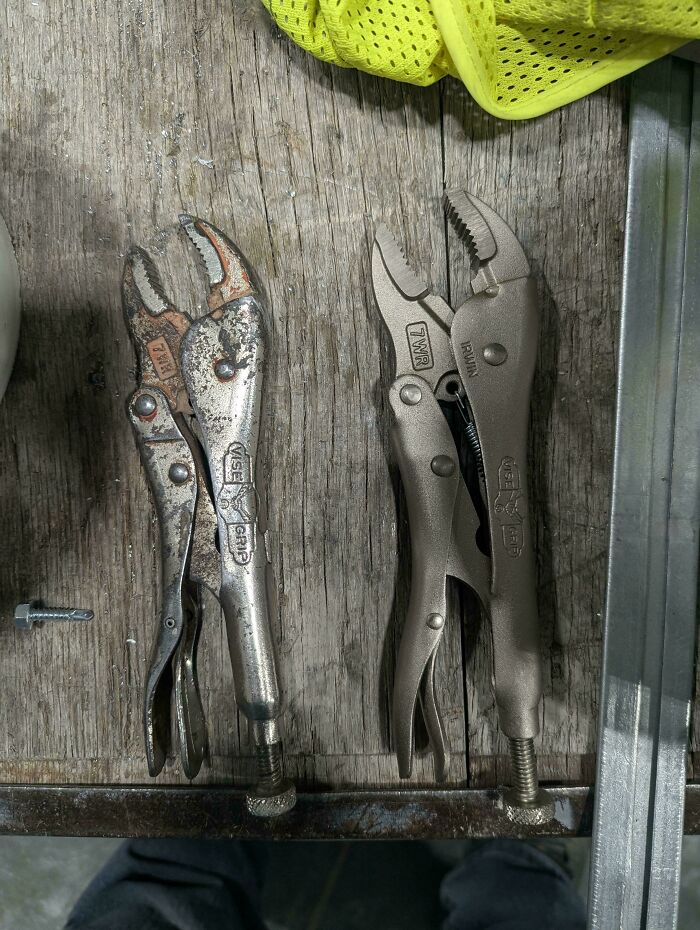 Pair of worn and new locking pliers placed side by side on a wooden surface showing wear on one tool.