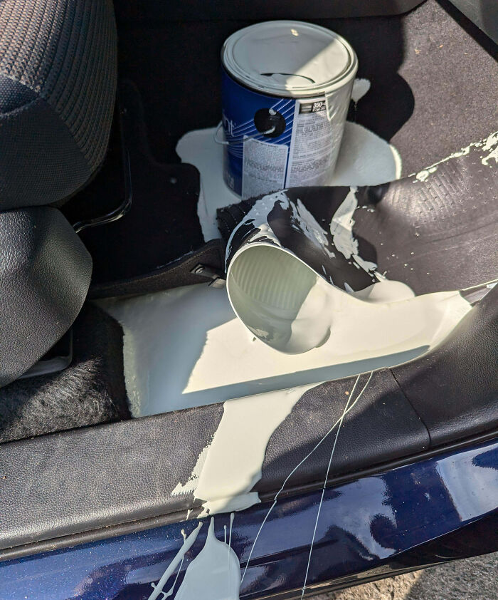 Spilled paint can inside car causing a messy expensive fail on the vehicle floor and seats.