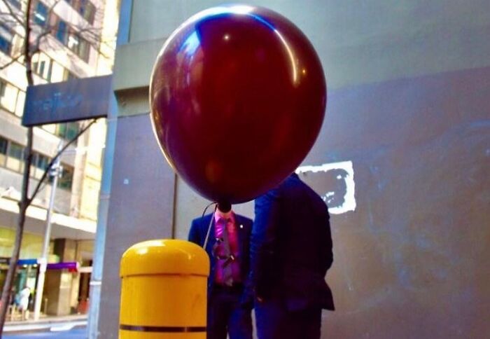 Street photographer captures perfect coincidences with a large balloon perfectly aligned in an urban setting.