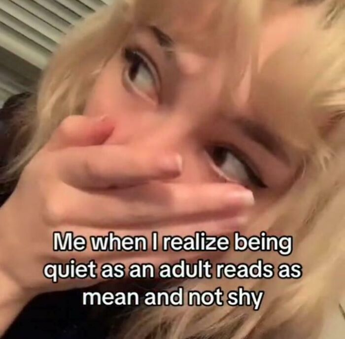 Young person with blonde hair covering their mouth, illustrating life with a spicy neurodivergent brain experience.