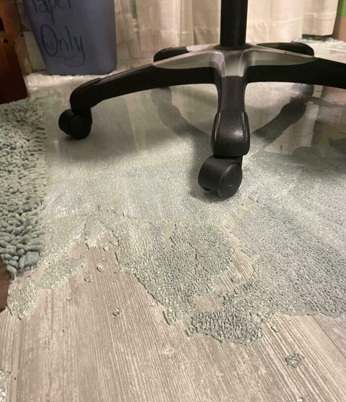 Office chair on a melted plastic floor protector showing an unfortunate and expensive fail in home setup.