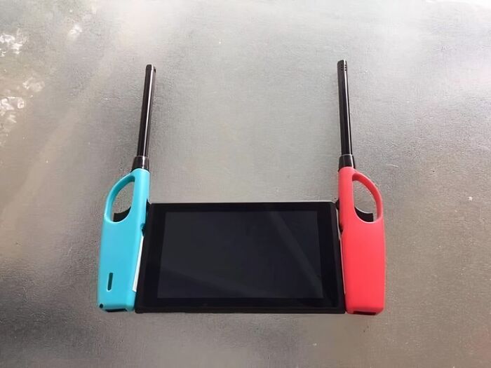 Two long lighters placed on each side of a tablet creating a confusing and funny visual illusion.