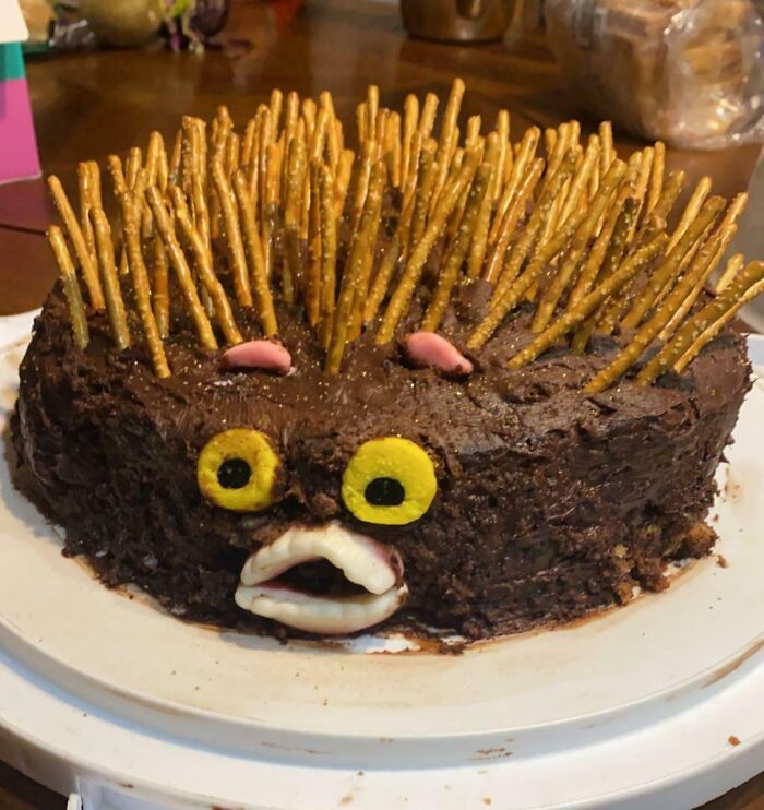 Chocolate dessert ruined with pretzel spikes and candy eyes, showcasing unexpected ways people managed to ruin dessert.