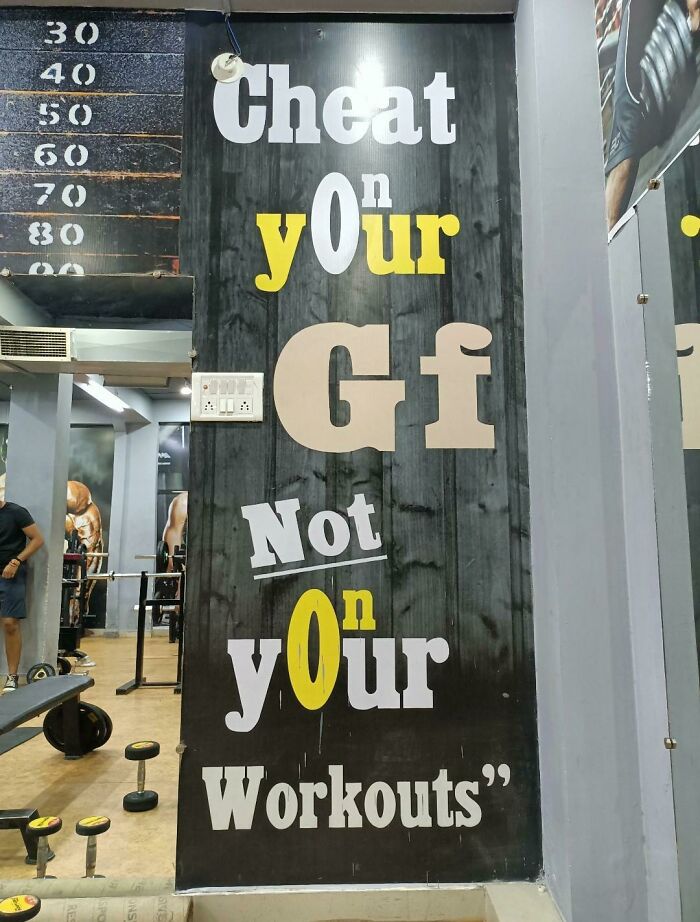 Funny gym wall text with design fail showing confusing typography and spelling errors by designers trying to write.