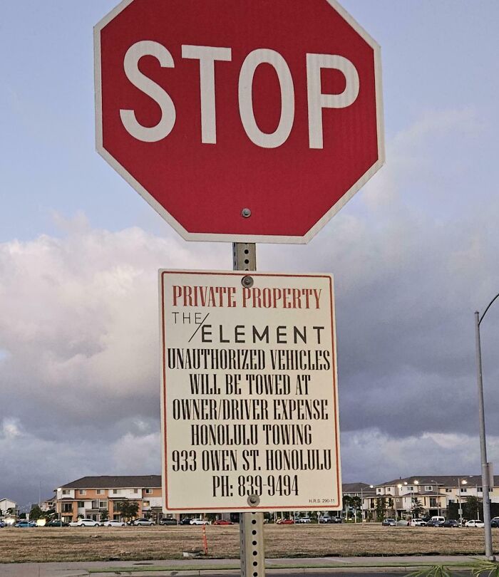 Stop sign above a confusing private property sign with poorly written text showing design fail by designers.