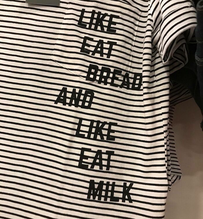 Striped shirt with confusing black text printed on it, showing an example of designers failing at writing and design.