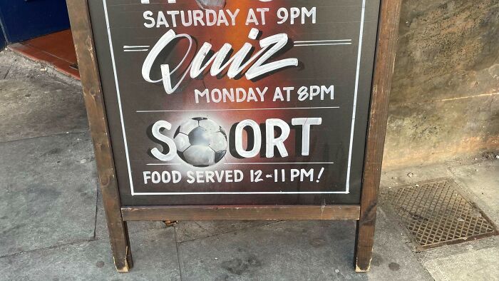 Chalkboard sign with text errors showing designers trying to write but failing miserably in street advertising.