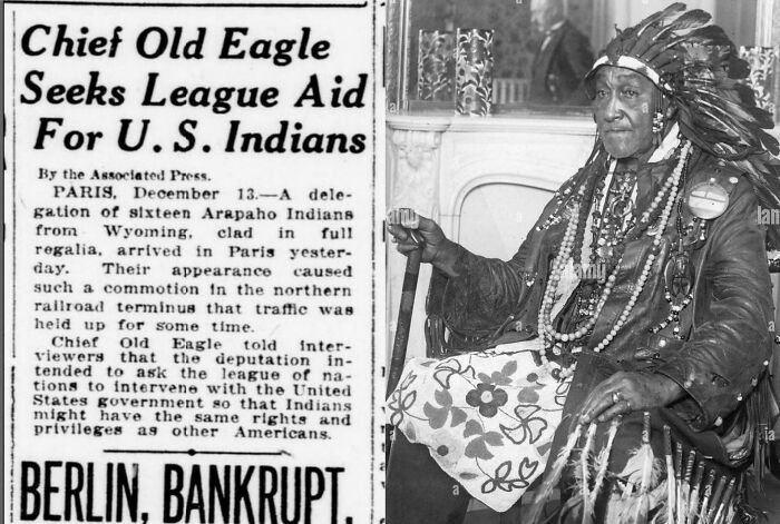 Black and white photo of Chief Old Eagle in full regalia with newspaper seeking aid for US Indians, historic US history moment.