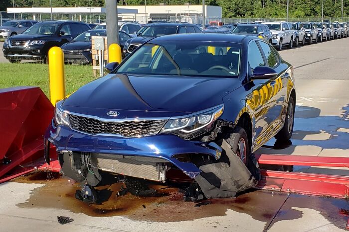 Blue Kia car with severe front-end damage, showcasing one of the dumb drivers caught in unbelievable accidents.
