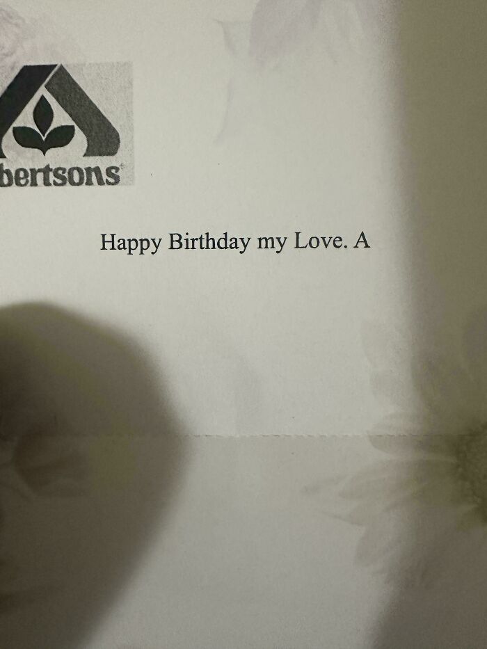 Unfortunate events shown in a printed birthday note with an incomplete message on floral paper background.