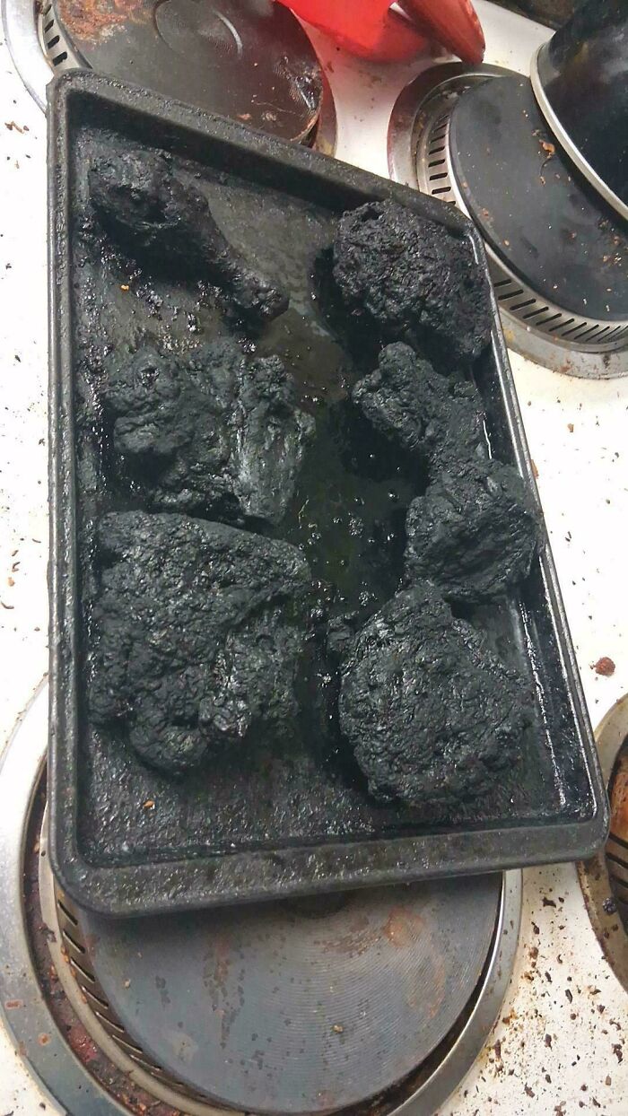 Burnt and charred food on a baking tray after an unfortunate cooking fail, a photo perfect for unfortunate events.