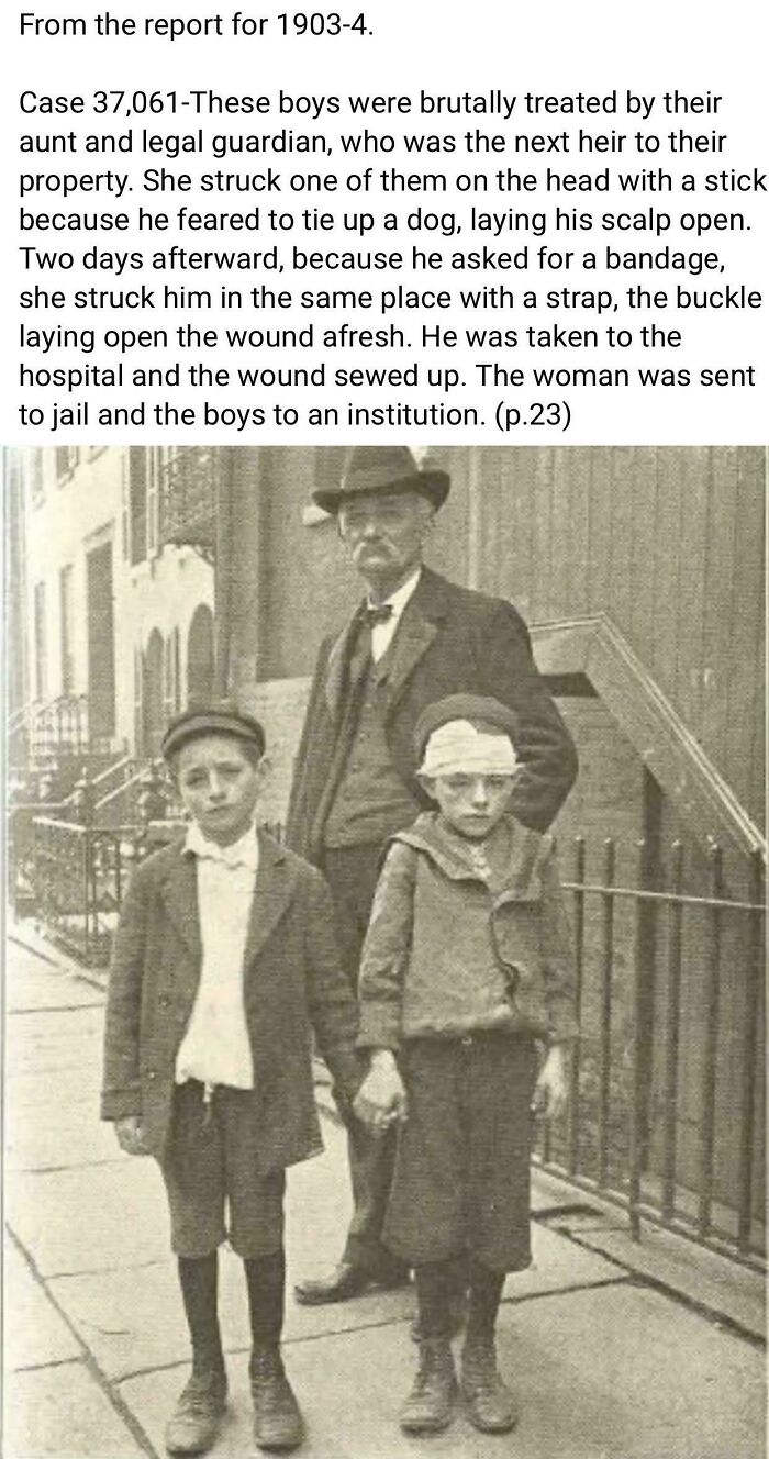 Two boys with head injuries stand on a city sidewalk in a historical photograph depicting harsh treatment from 1903.