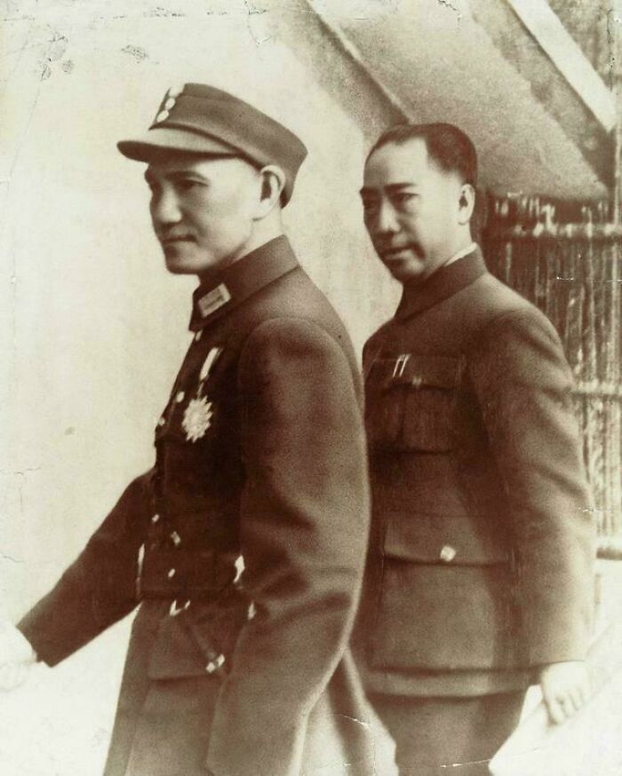 Two men in vintage military uniforms in a historical photograph depicting a world you'd hardly recognize today.