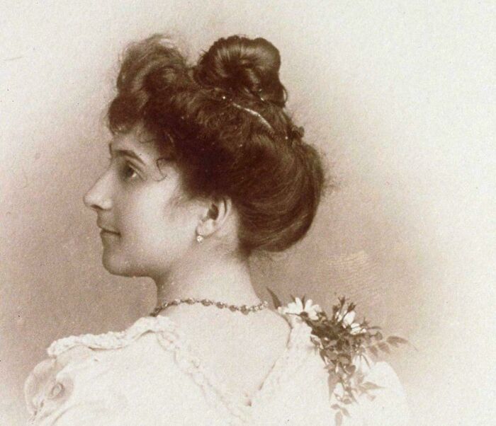 Victorian-era woman with an elegant hairstyle and dress in an interesting historical photograph.