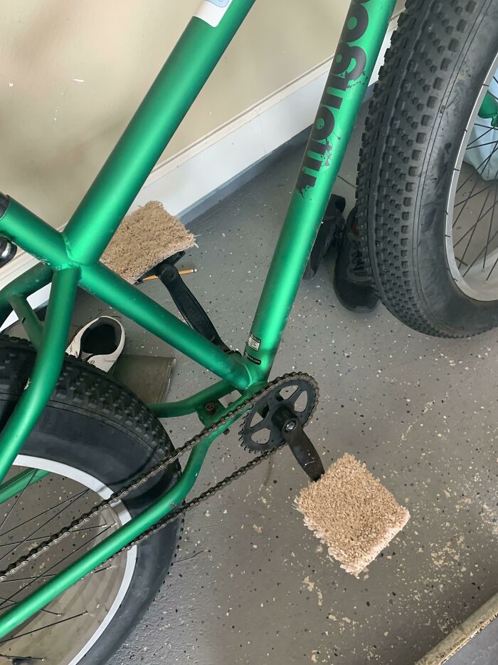 Green bicycle with carpet attached to pedals as an unusual example of if its stupid but it works then its not stupid.
