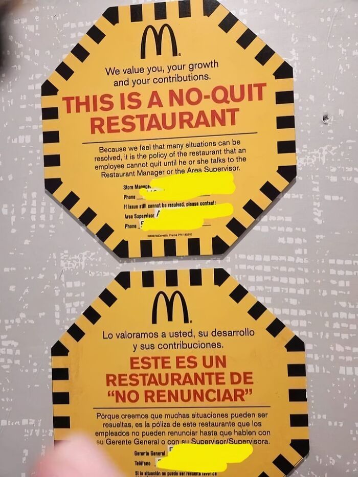 Two yellow McDonald's no-quit restaurant signs in English and Spanish illustrating a dystopia work policy.